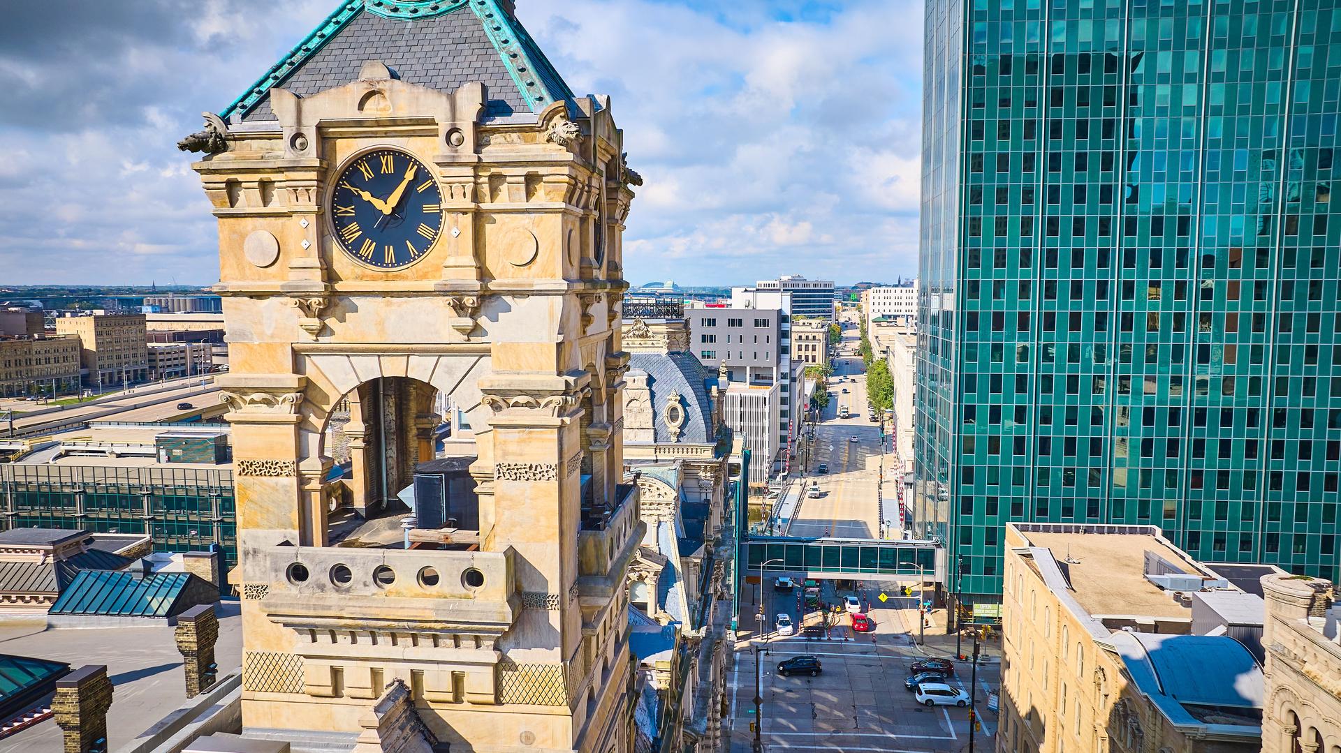 Aerial View of Historic Clock Tower and Modern Skyscrapers in Urban Cityscape